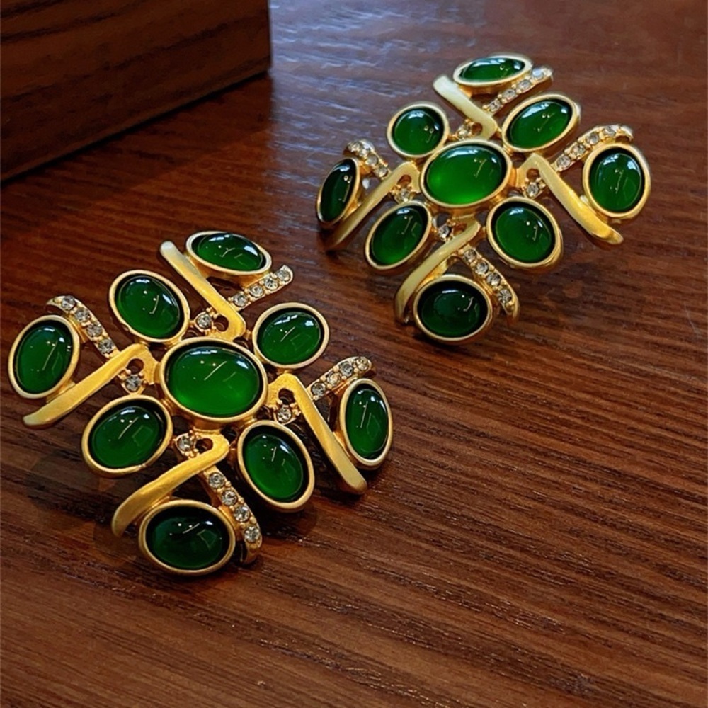 Vintage-inspired gold-tone statement earrings featuring rich green cabochon